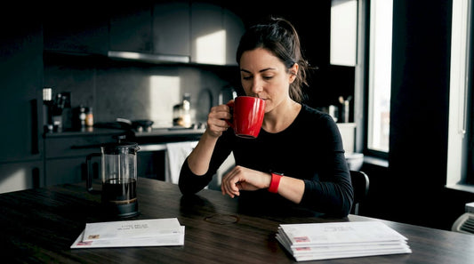 Woman with coffee mug checking her watch